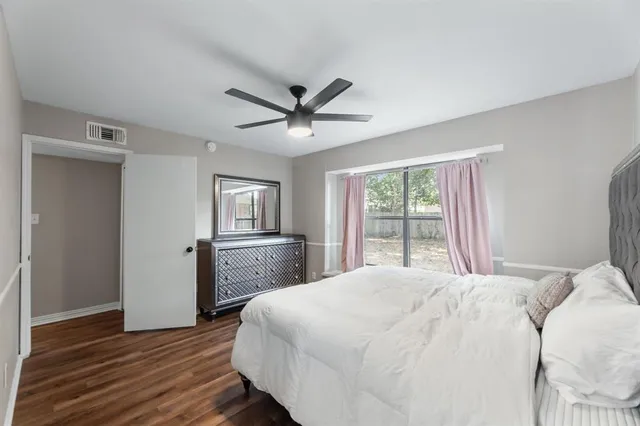 a bedroom with a large bed and a window