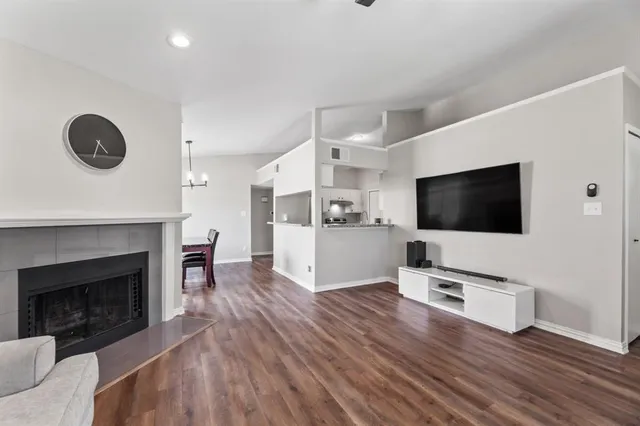 a living room with furniture wooden floor and a fireplace