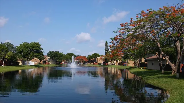 a view of residential house with outdoor space and lake