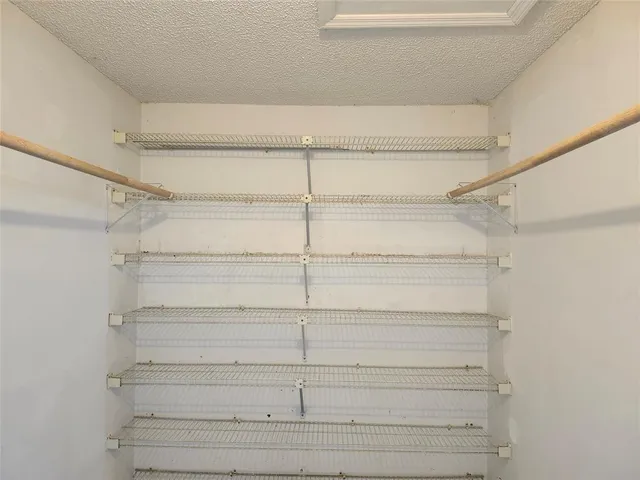 a view of a room with shelves on the wall