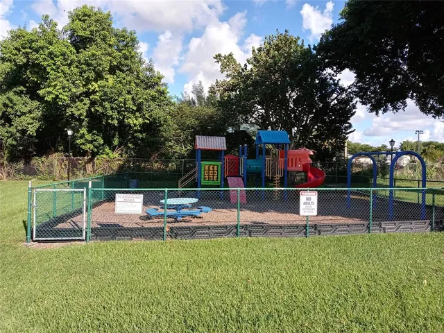 a view of a house with swimming pool and a yard