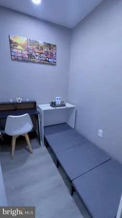 a view of a room with furniture and wooden floor
