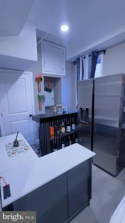 a kitchen with a refrigerator and a sink