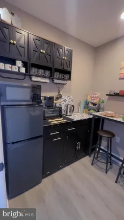 a kitchen with stainless steel appliances granite countertop a refrigerator a sink and a stove