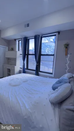 a bedroom with a bed and a window