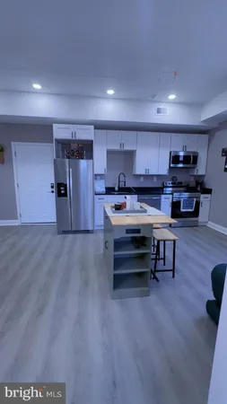 a view of kitchen appliances and wooden floor