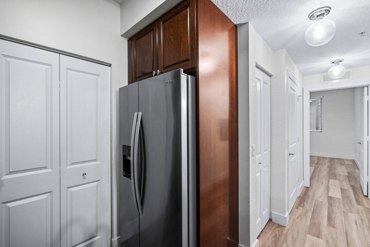 1117 Renaissance Way, Unit 117 Boynton Beach, FL 33426 - Photo 13 of 31 a view of a refrigerator and wooden floor