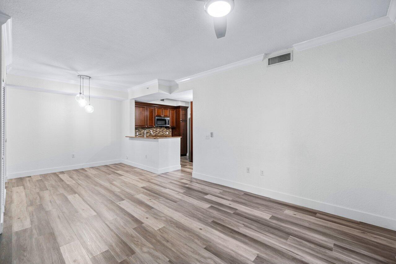 1117 Renaissance Way, Unit 117 Boynton Beach, FL 33426 - Photo 7 of 31 a view of empty room with wooden floor
