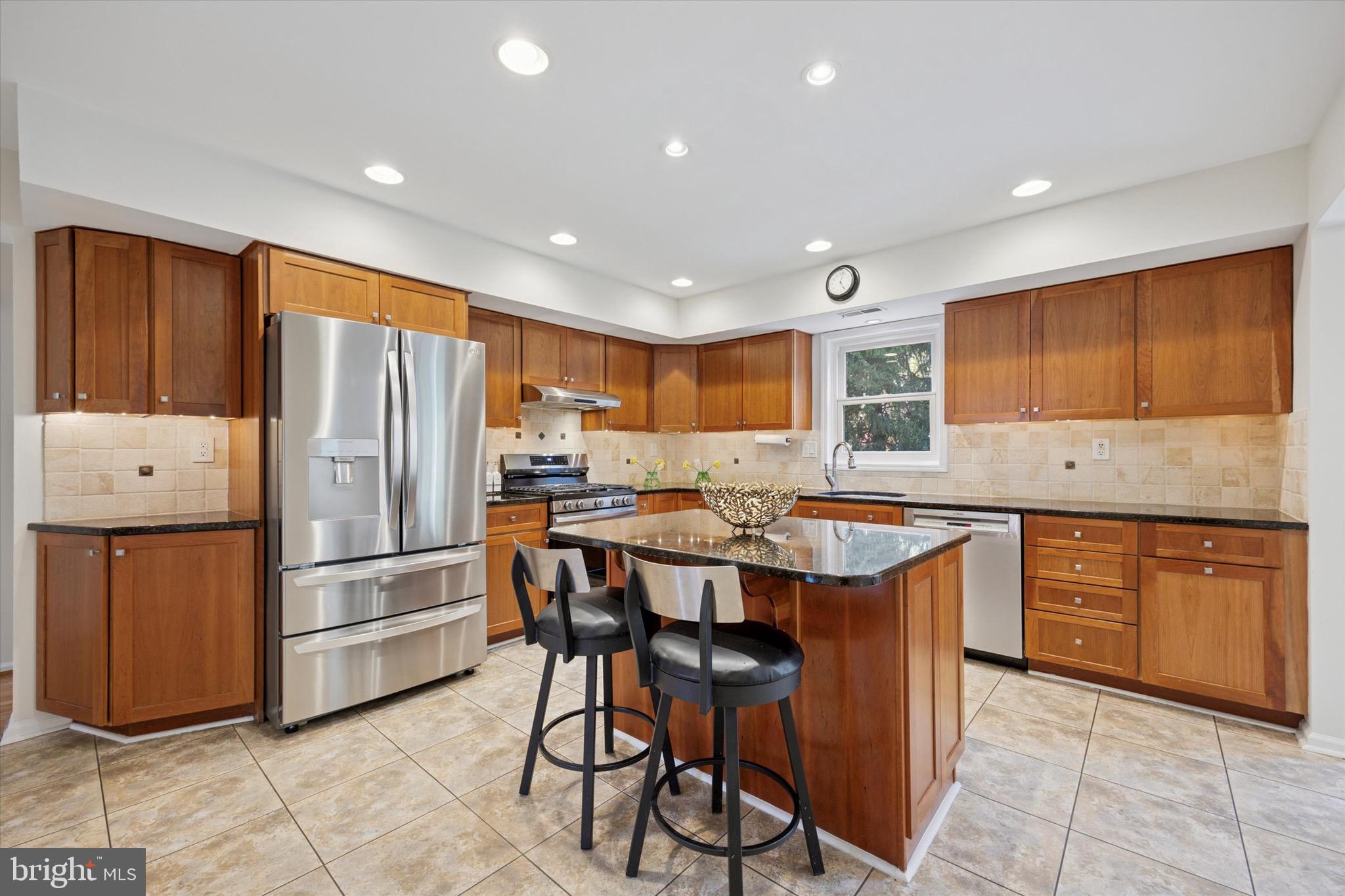 713 Buckley Road Blue Bell, PA 19422 - Photo 12 of 44 a kitchen with stainless steel appliances granite countertop a refrigerator and wooden cabinets