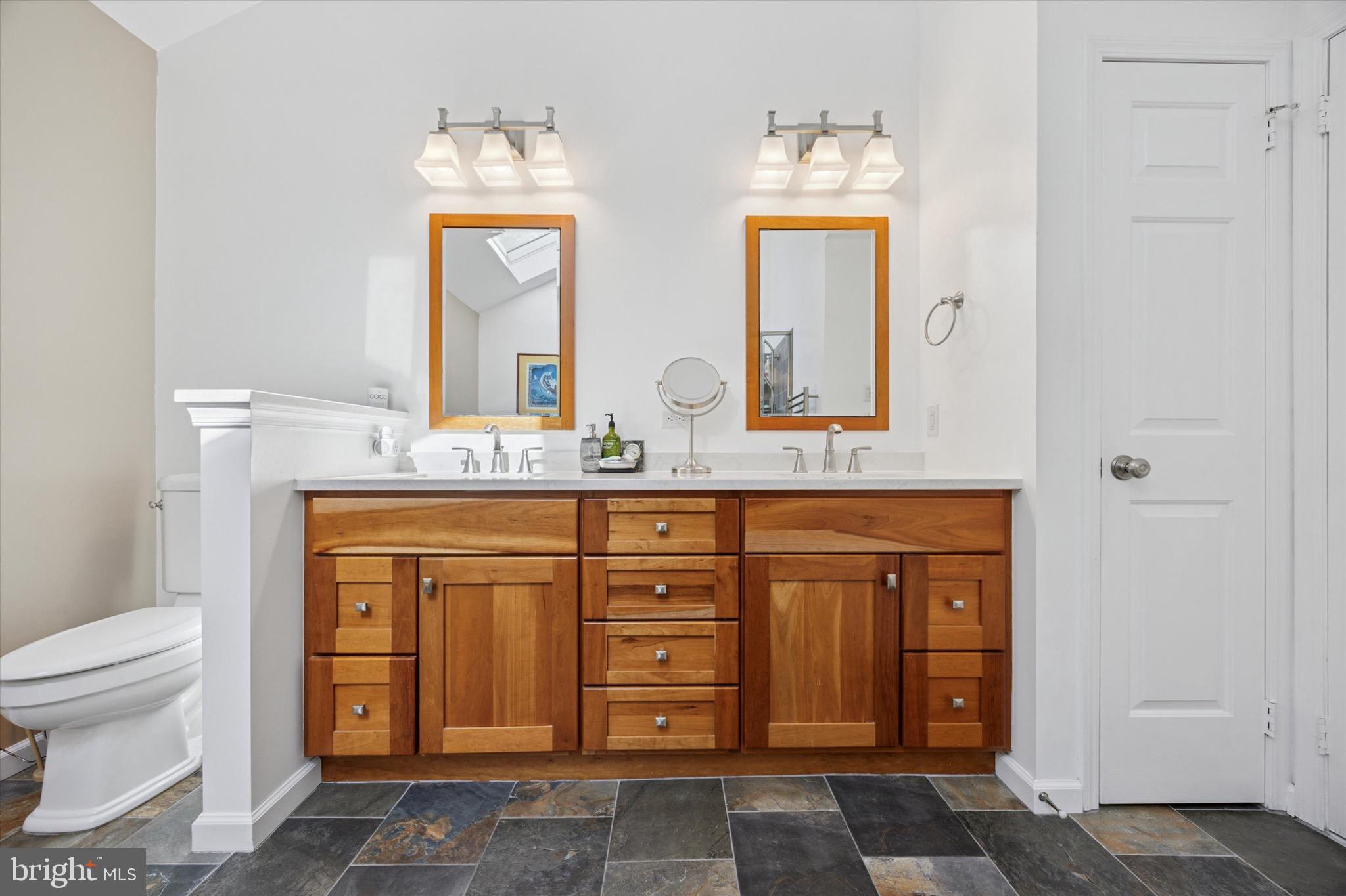 713 Buckley Road Blue Bell, PA 19422 - Photo 23 of 44 a spacious bathroom with a granite countertop toilet sink and mirror
