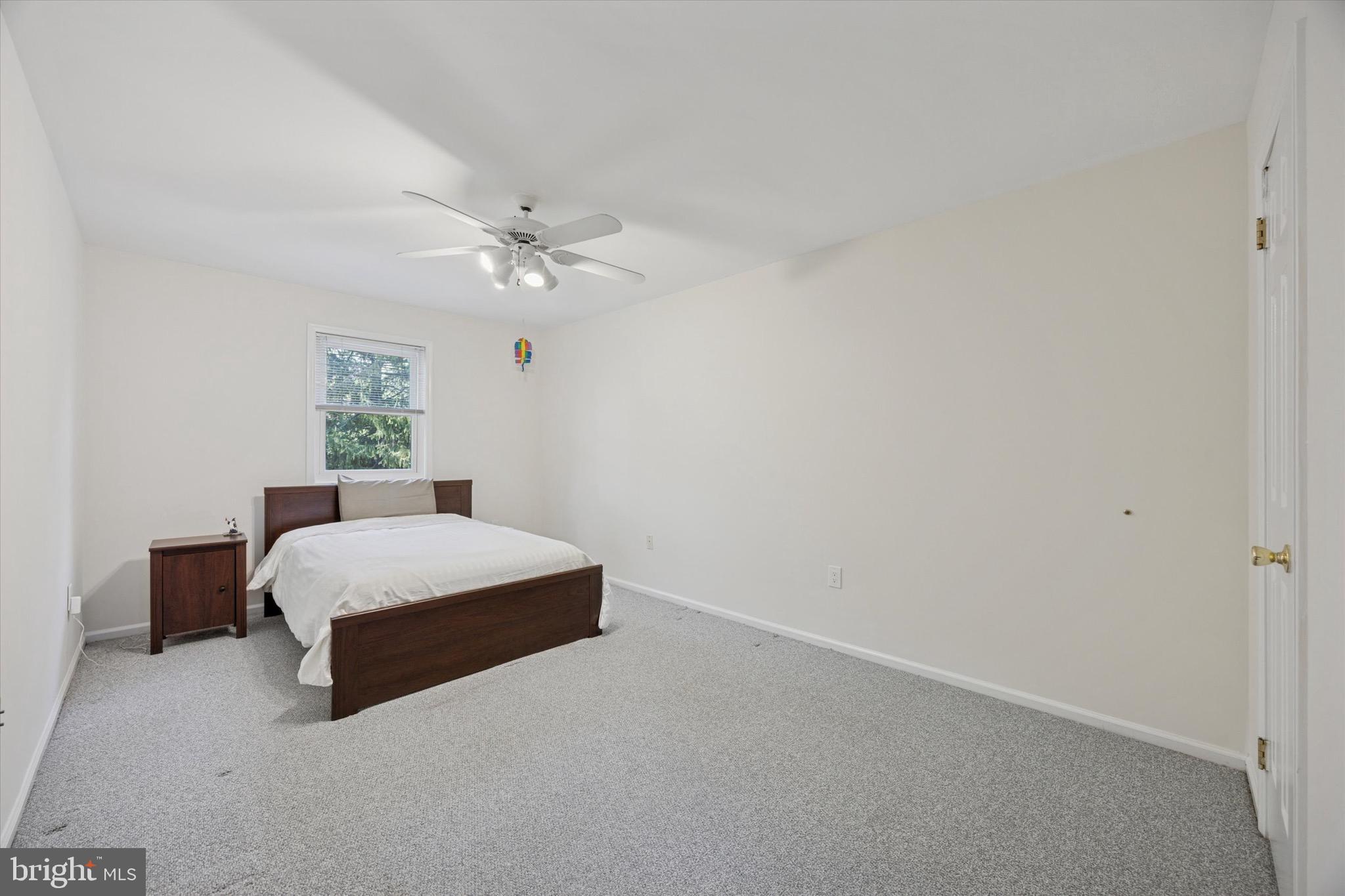 713 Buckley Road Blue Bell, PA 19422 - Photo 25 of 44 a room with a bed and a chandelier fan