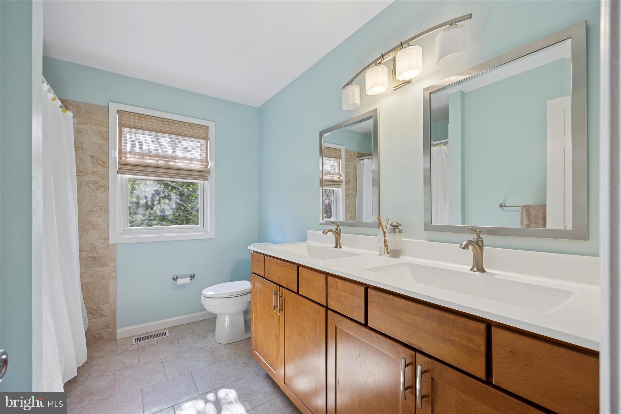 713 Buckley Road Blue Bell, PA 19422 - Photo 28 of 44 a bathroom with a toilet sink and mirror