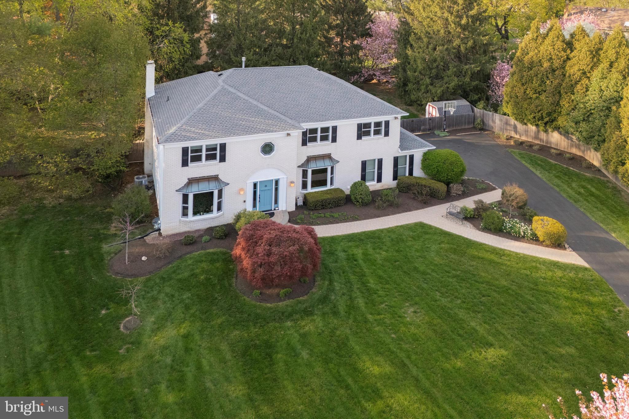 713 Buckley Road Blue Bell, PA 19422 - Photo 37 of 44 a aerial view of a house with table and chairs under an umbrella