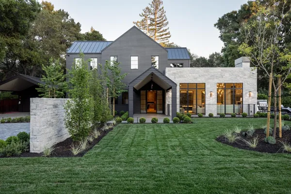 a front view of a house with a garden