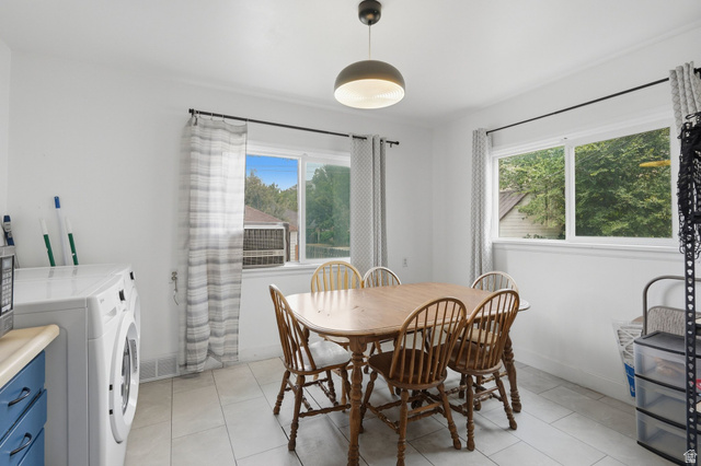 707 East 150 South Provo, UT 84606 - Photo 10 of 31 Dining area and upstairs laundry with white walls, a single ceiling light fixture, and tile flooring