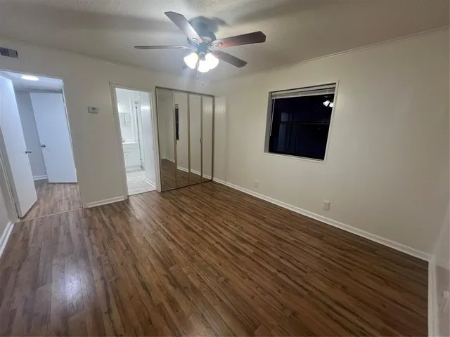a backyard of a house with barbeque oven and trees