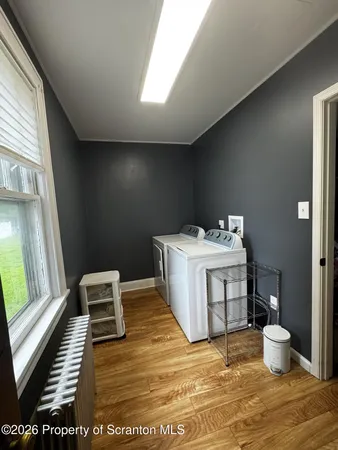 a view of a storage & utility room with two washing machine