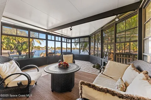 an aerial view of a house with swimming pool and outdoor seating