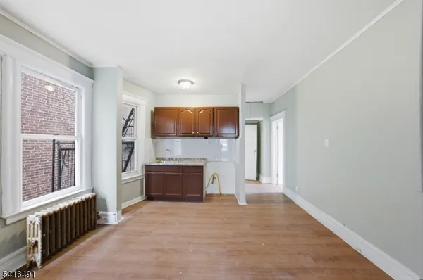 a view of a kitchen with a sink and a refrigerator