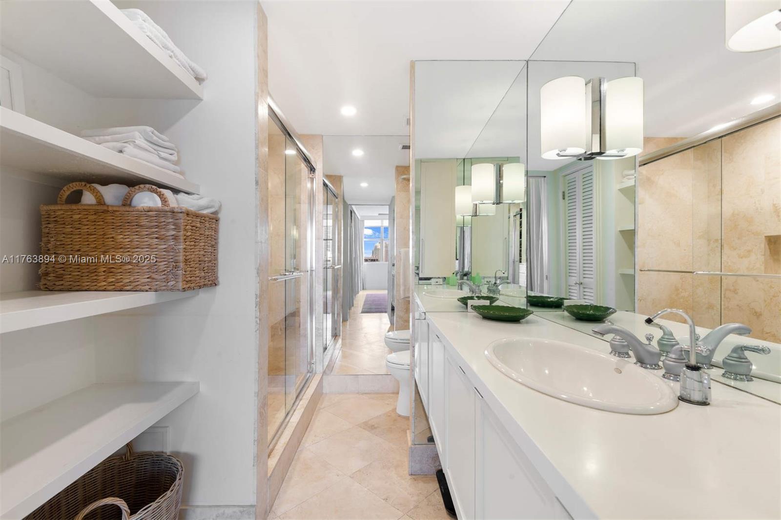 20 Island Avenue, Unit 1509 Miami Beach, FL 33139 - Photo 21 of 34 a bathroom with a double vanity sink a mirror and a shower