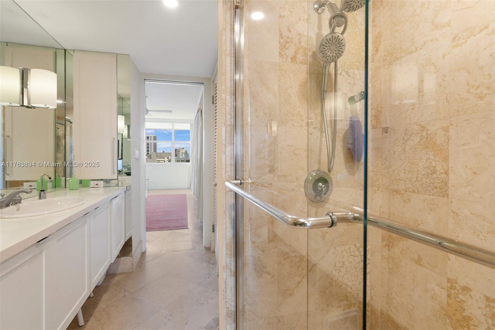20 Island Avenue, Unit 1509 Miami Beach, FL 33139 - Photo 22 of 34 a bathroom with a double vanity sink a mirror and shower
