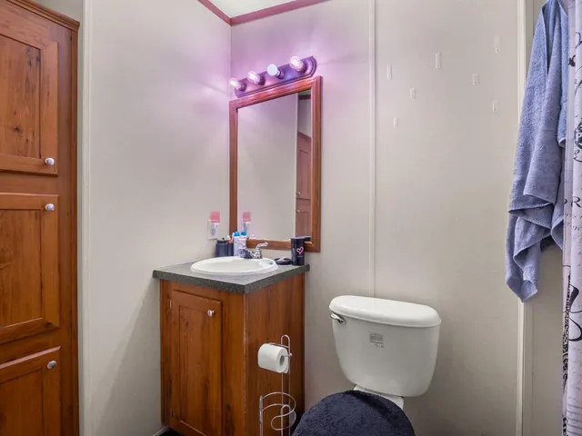 a bathroom with a toilet sink and mirror