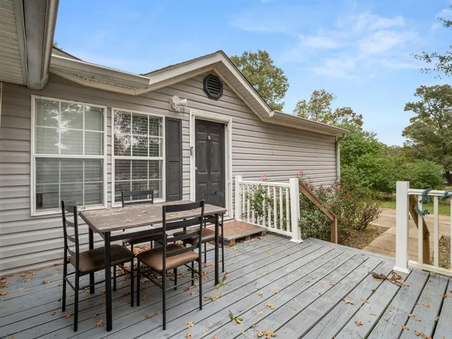 a view of a roof deck with table and chairs floor to ceiling window with wooden floor