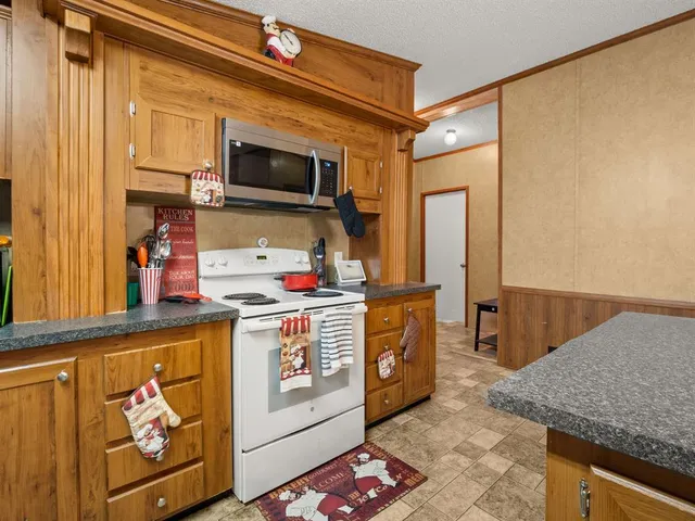 a kitchen with stainless steel appliances granite countertop a stove and a microwave