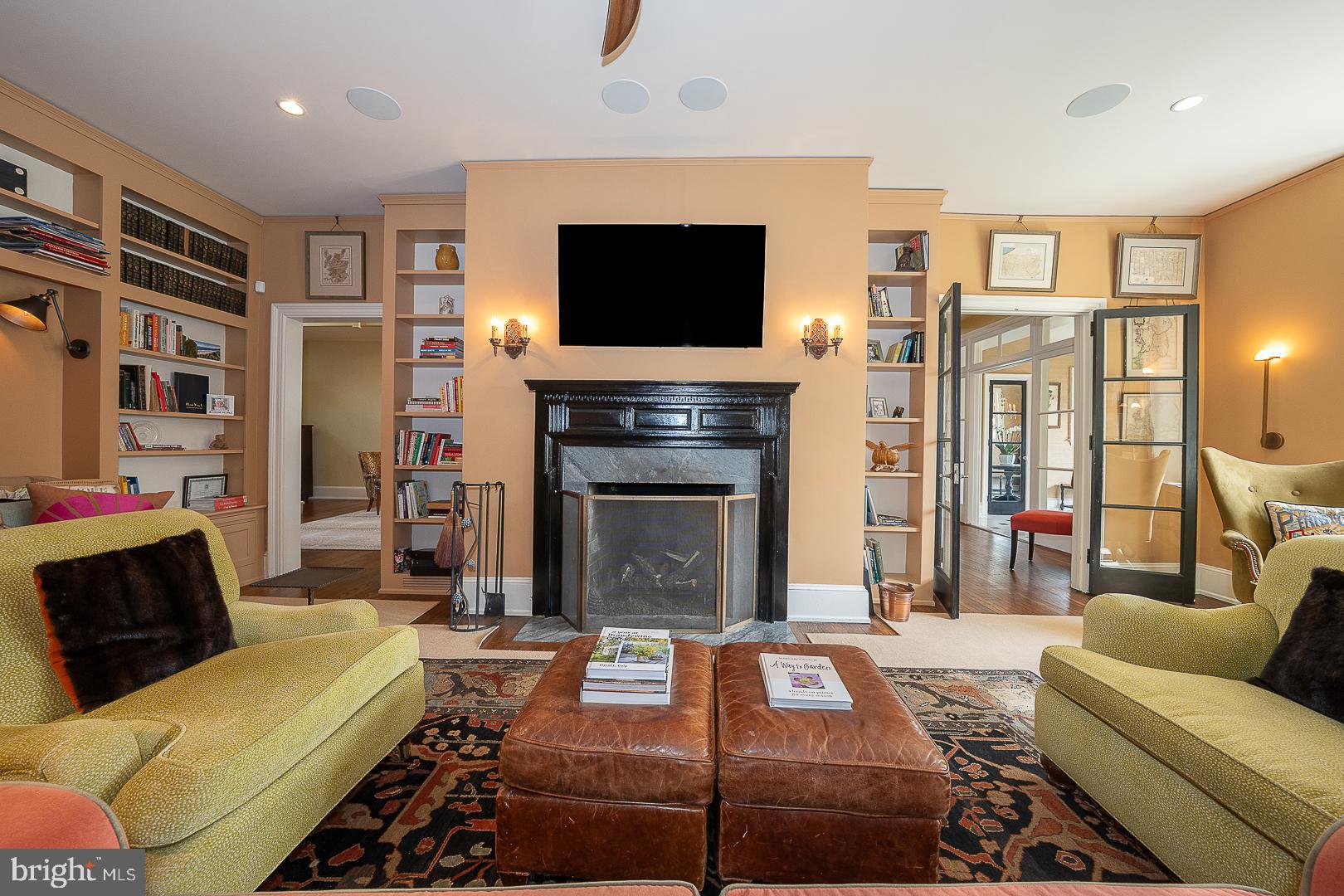 3501 Goshen Road Newtown Square, PA 19073 - Photo 14 of 79 a living room with furniture a flat screen tv and a fireplace