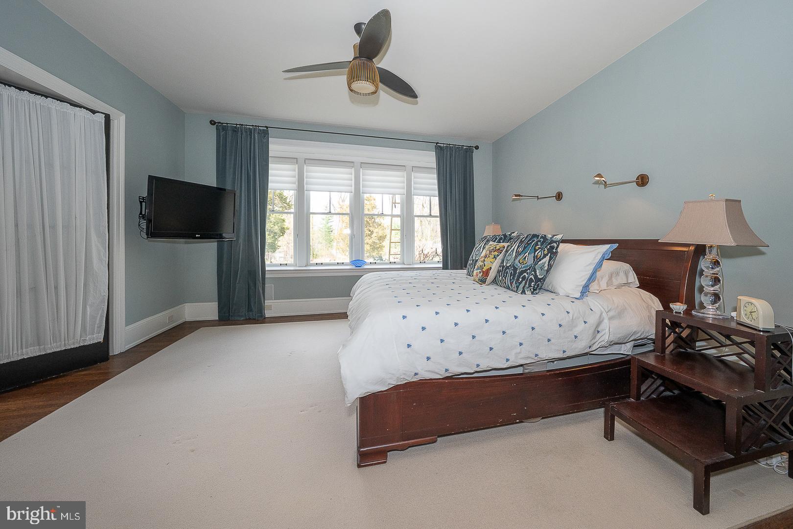 3501 Goshen Road Newtown Square, PA 19073 - Photo 21 of 79 a bedroom with a bed and a flat tv screen on the dresser
