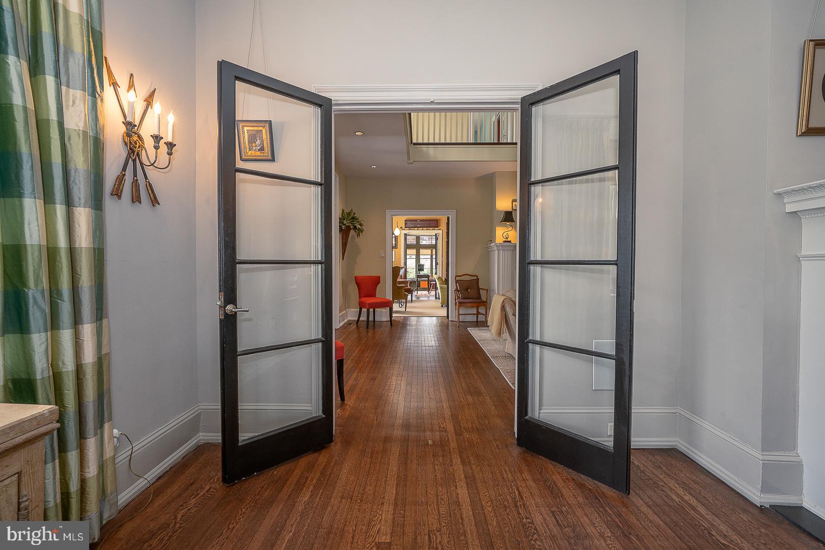 3501 Goshen Road Newtown Square, PA 19073 - Photo 27 of 79 a view of a hallway with wooden floor and a living room