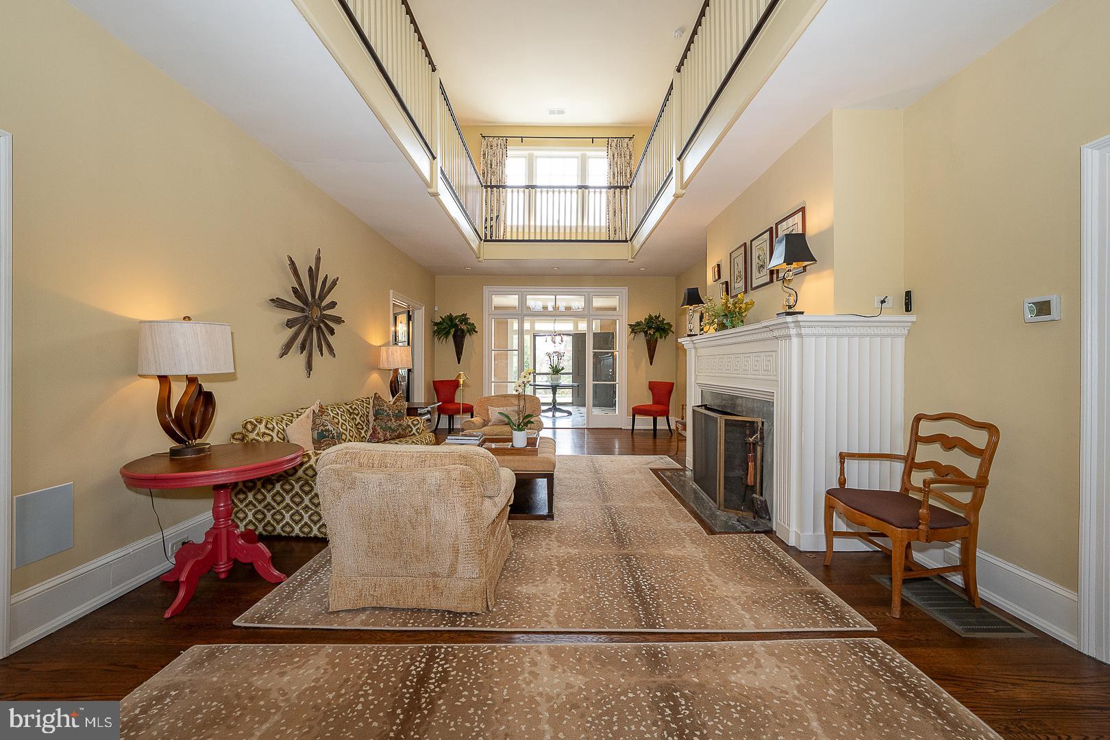 3501 Goshen Road Newtown Square, PA 19073 - Photo 10 of 79 a living room with furniture a fireplace and a dining table with rug