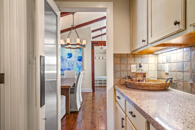 a kitchen with stainless steel appliances granite countertop a refrigerator and a stove