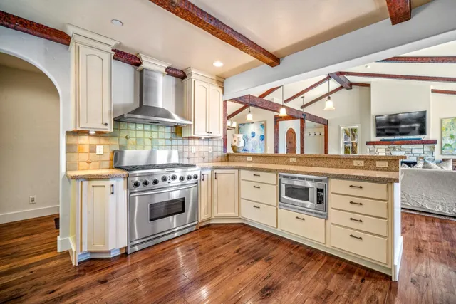 a large bed sitting in a bedroom next to a window