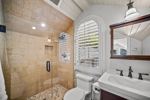 a spacious bedroom with a bed and a fireplace