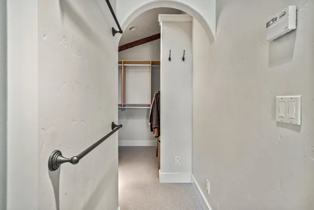 a bedroom with a bed couch and a window