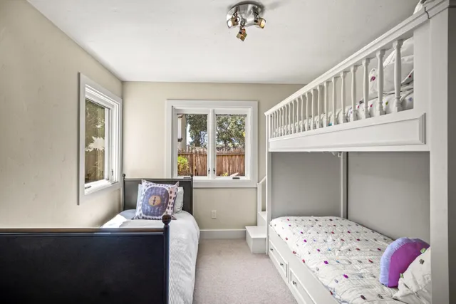 a bathroom with a granite countertop toilet sink and mirror