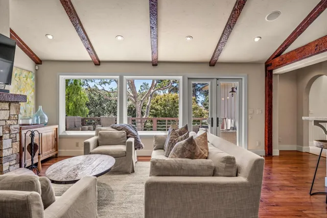 a living room with furniture and large windows