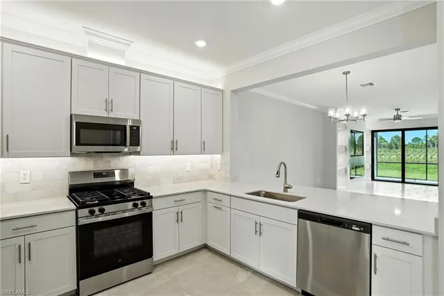 a kitchen with a sink stove and microwave
