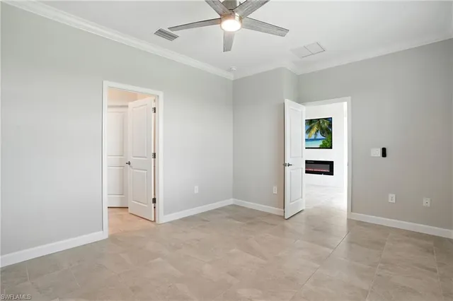 an empty room with fan and entrance
