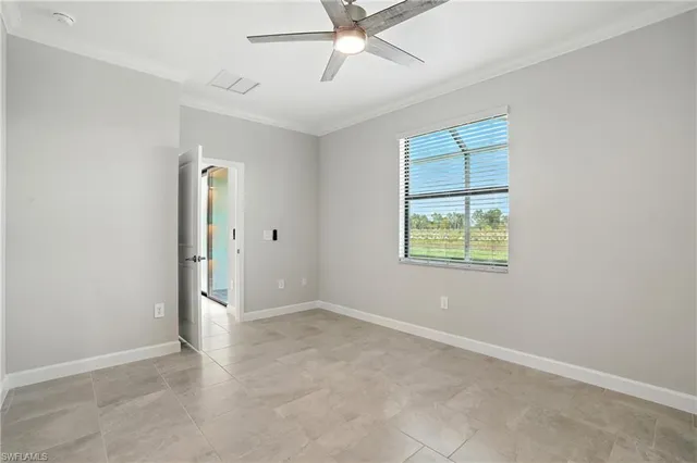 an empty room with fan and windows