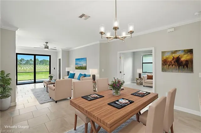 a living room with furniture a window and a chandelier