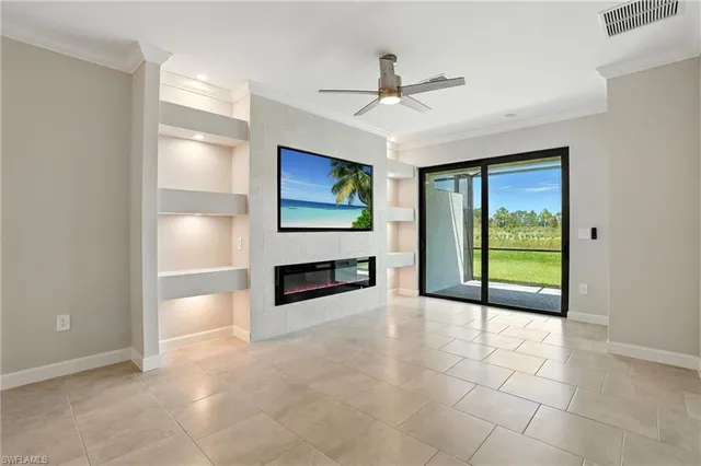 a view of a livingroom with a ceiling fan and window