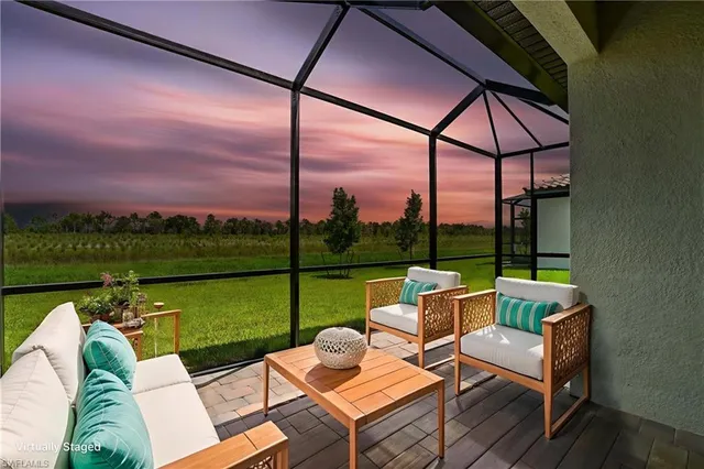 an outdoor sitting area with couch and chairs