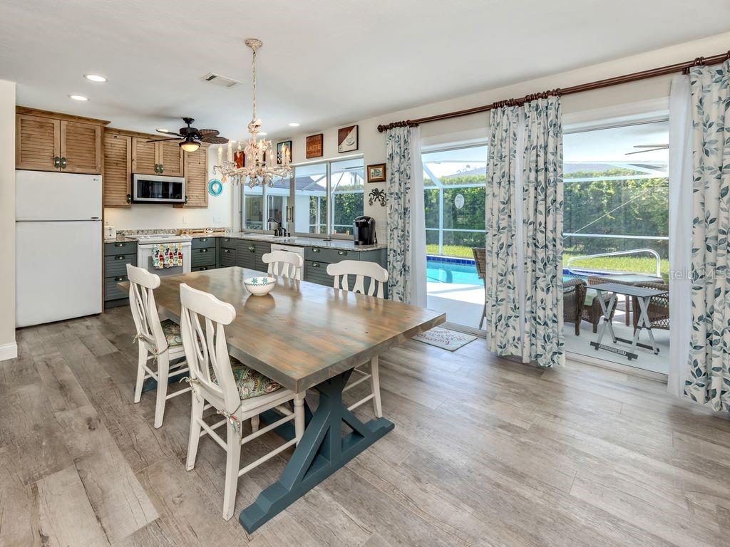 601 Apalachicola Road Venice, FL 34285 - Photo 2 of 33 a view of a dining room with furniture window and wooden floor