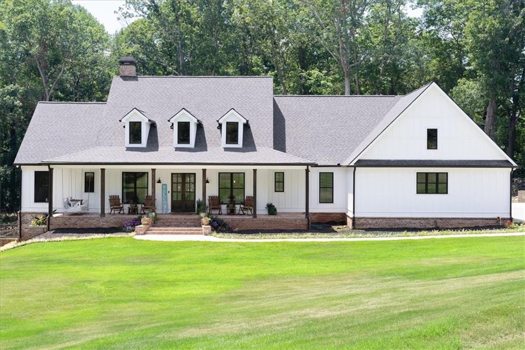 a front view of a house with a yard patio and fire pit