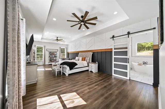 a bathroom with a sink a bathtub a mirror a vanity and a shower