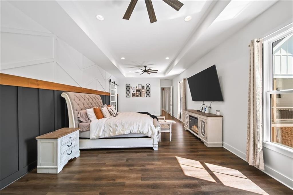 1380 Cronic Town Road Auburn, GA 30011 - Photo 16 of 69 a spacious bedroom with a bed and a flat screen tv