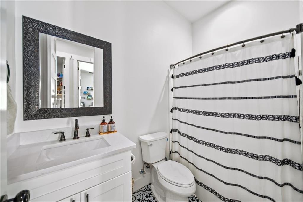 1380 Cronic Town Road Auburn, GA 30011 - Photo 26 of 69 a bathroom with a toilet a sink and a mirror