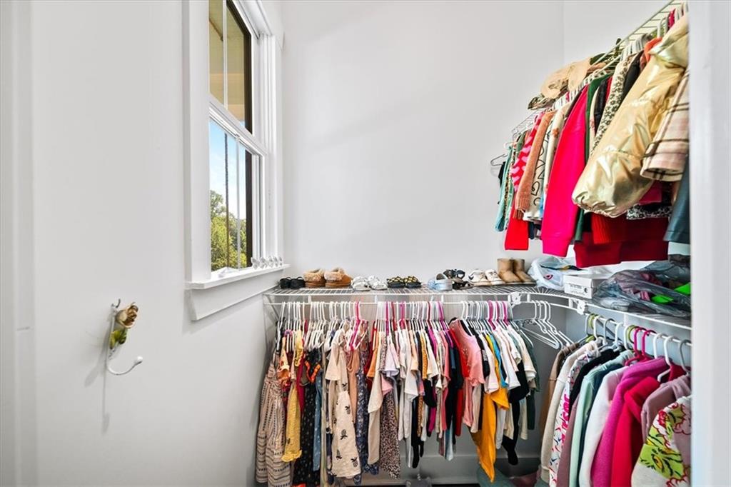 1380 Cronic Town Road Auburn, GA 30011 - Photo 29 of 69 a view of walk in closet with clothes and shoes